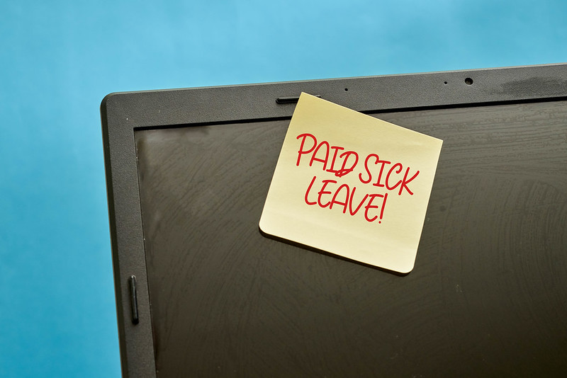 post-it with paid sick leave written on it