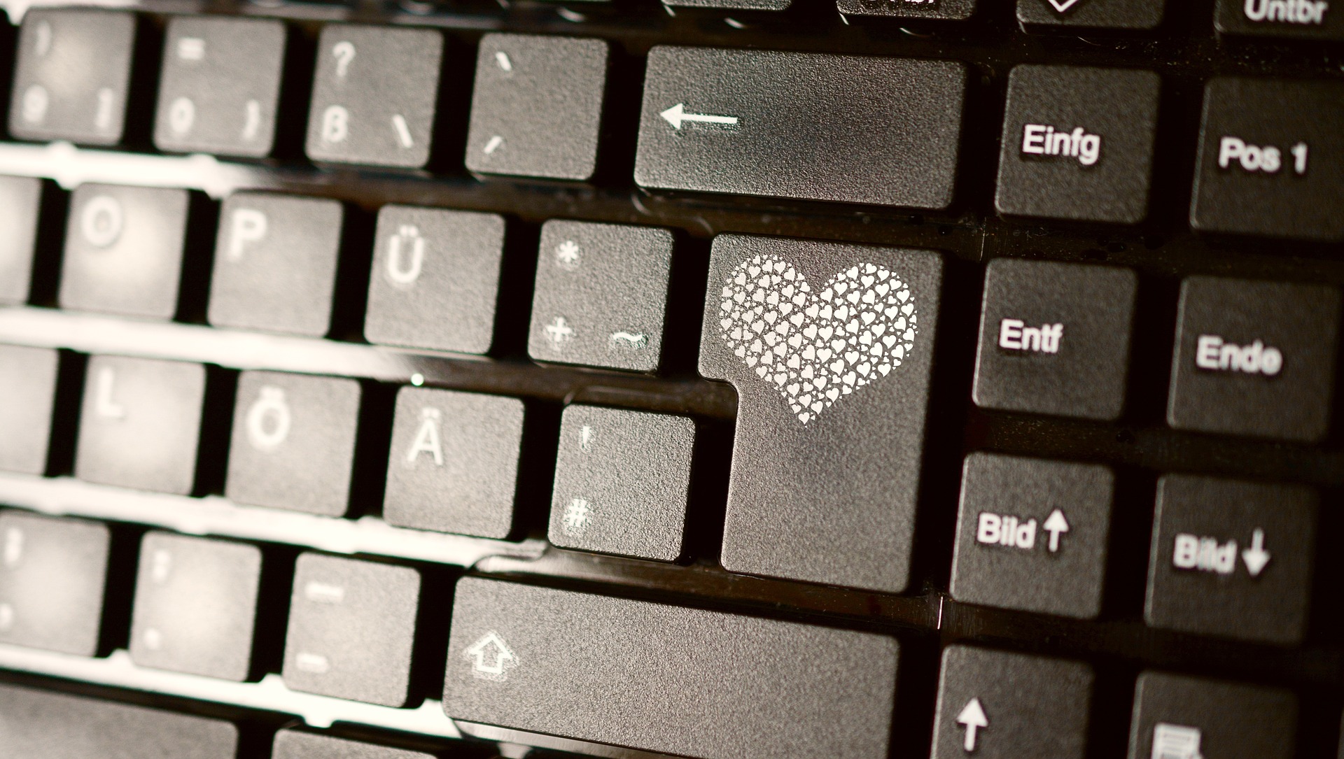 computer keyboard with heart on the enter key