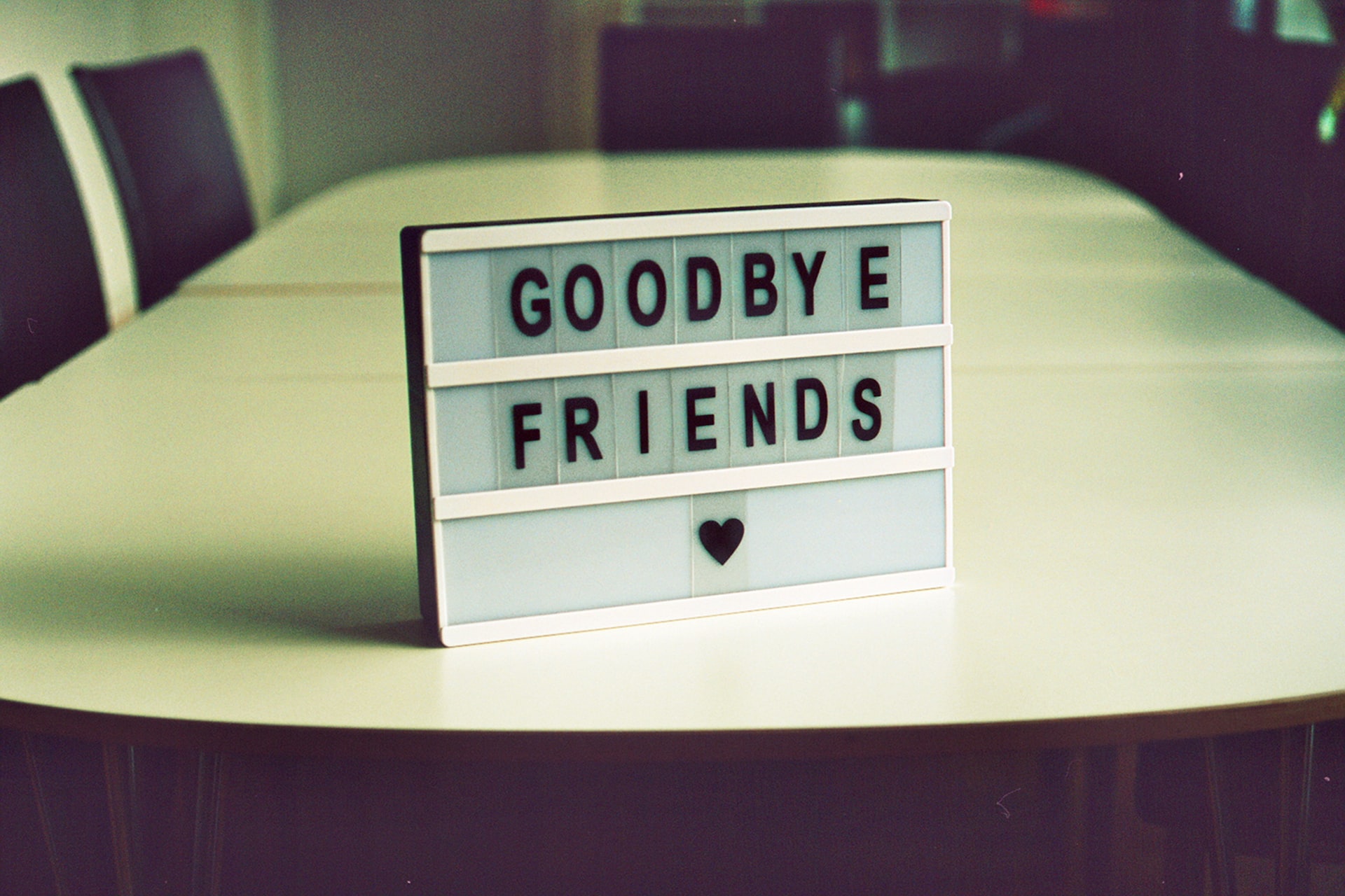 goodbye friends sign on board room table